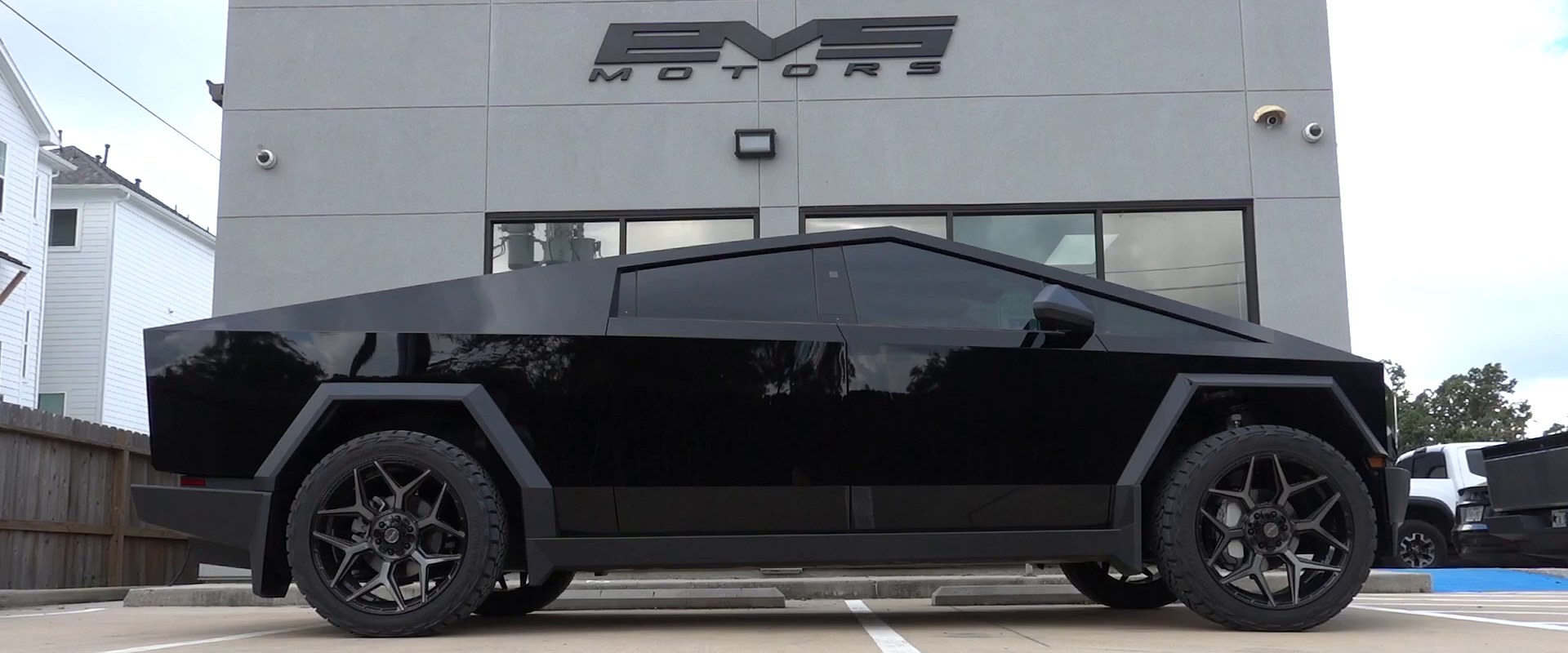 The EVS Motors shop in Houston with a blacked-out Cybertruck out front
